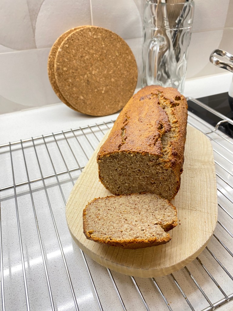 Sliced banana bread loaf on a cutting board